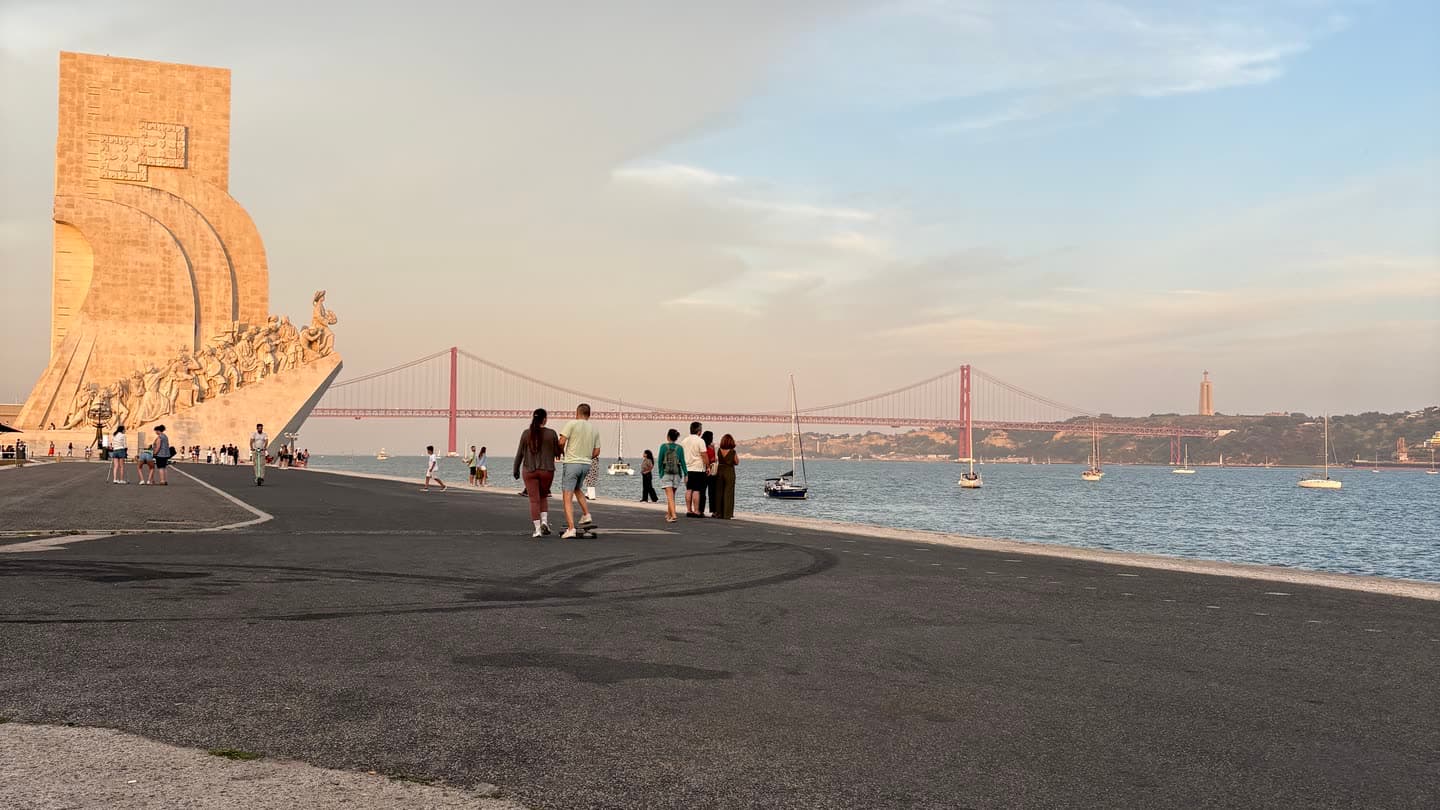 The Belém waterfront in Lisbon, low sun on the water and the promenade almost empty