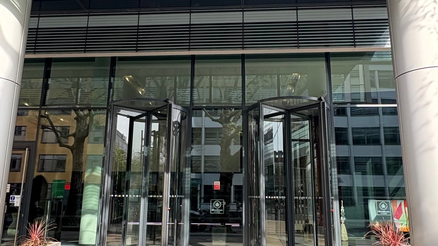 The glass revolving doors at the entrance of a modern office building